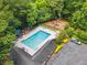 Aerial view showcasing the community pool, playset, landscaping, parking, and surrounding greenery at 3506 Billingsley Dr, Marietta, GA 30062