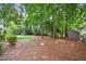 Beautiful, wooded backyard with a playset and storage shed providing ample space at 3506 Billingsley Dr, Marietta, GA 30062