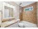 Bathroom featuring granite counters, shower-tub, and earth-toned ceramic tile at 3506 Billingsley Dr, Marietta, GA 30062