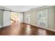 Bedroom featuring hardwood floors, two windows, and a sliding barn door for convenient access to the hallway at 3506 Billingsley Dr, Marietta, GA 30062