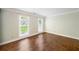 Bright bedroom featuring hardwood floors and two large windows with a view of the landscaped front yard at 3506 Billingsley Dr, Marietta, GA 30062