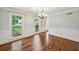 Sun-filled dining room featuring hardwood floors, wainscoting, and a modern chandelier at 3506 Billingsley Dr, Marietta, GA 30062