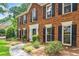 Close-up of a stately brick home featuring a well-manicured lawn and classic black shutters at 3506 Billingsley Dr, Marietta, GA 30062
