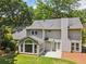 Back exterior featuring a patio, sunroom, and well-maintained lawn and landscaping at 3506 Billingsley Dr, Marietta, GA 30062