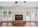 Living room with fireplace, hardwood floors, and French doors leading to the outdoor patio at 3506 Billingsley Dr, Marietta, GA 30062