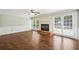Living room with hardwood floors, a fireplace, and access to the backyard patio through French doors at 3506 Billingsley Dr, Marietta, GA 30062
