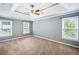 Spacious main bedroom with tray ceilings, plush carpeting, and bright, natural light at 3506 Billingsley Dr, Marietta, GA 30062