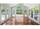 Sunroom featuring hardwood floors, ceiling fan, and large windows bringing in natural light overlooking backyard at 3506 Billingsley Dr, Marietta, GA 30062
