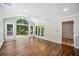 Bright sunroom featuring hardwood floors, ceiling fan, and large windows with views of the backyard at 3506 Billingsley Dr, Marietta, GA 30062