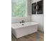 Luxurious soaking tub with elegant fixtures and a serene view from the window at 2101 Thomas Rd, Canton, GA 30115