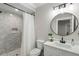 Modern bathroom with gray tile, a walk-in shower and a round mirror at 2101 Thomas Rd, Canton, GA 30115