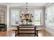 Elegant dining room featuring a rustic wooden table, bench seating, and modern chandelier at 2101 Thomas Rd, Canton, GA 30115