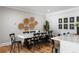 This dining room features a long table with seating for eight under decorative wicker-style art at 2101 Thomas Rd, Canton, GA 30115