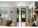 Elegant entryway with French doors leading to a lush backyard and wood-look tile floors at 2101 Thomas Rd, Canton, GA 30115