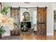 Charming entryway featuring rustic barn doors, hardwood floors, and stylish decor at 2101 Thomas Rd, Canton, GA 30115