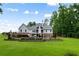 Two-story home with manicured landscaping, pool, patio, and lush green lawn at 2101 Thomas Rd, Canton, GA 30115