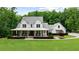 Stunning two-story modern farmhouse with a welcoming front porch and professionally landscaped lawn at 2101 Thomas Rd, Canton, GA 30115
