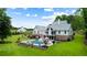 Stunning two-story home with a manicured lawn, lush landscaping, pool and patio at 2101 Thomas Rd, Canton, GA 30115
