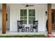 Inviting front porch featuring rocking chairs, wooden columns, and a ceiling fan at 2101 Thomas Rd, Canton, GA 30115