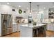 Bright kitchen features a large center island with pendant lights, stainless steel appliances, and white cabinetry at 2101 Thomas Rd, Canton, GA 30115