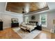 Comfortable main bedroom featuring a wood tray ceiling, neutral decor, and ample natural light at 2101 Thomas Rd, Canton, GA 30115