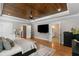 Serene main bedroom featuring a tray ceiling, hardwood floors, and modern furnishings at 2101 Thomas Rd, Canton, GA 30115