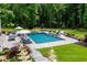 Gorgeous in-ground pool with a hot tub, outdoor seating, and lush landscaping at 2101 Thomas Rd, Canton, GA 30115