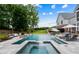 Resort-style pool area with lounge chairs, umbrellas, and lush landscaping at 2101 Thomas Rd, Canton, GA 30115