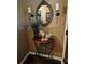 Close-up of foyer decor, including a decorative mirror, candles, and a bird sculpture on a wooden table at 4094 Carlisle Pl, Stone Mountain, GA 30083