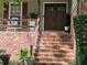 Inviting front entrance with brick steps, wooden doors, and decorative plants showcasing curb appeal at 4094 Carlisle Pl, Stone Mountain, GA 30083