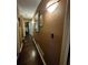 Hallway featuring hardwood floors, warm paint and decorative pictures and lighting at 4094 Carlisle Pl, Stone Mountain, GA 30083