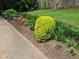 Lush landscaping featuring a decorative border of colorful flowers and well-manicured bushes at 4094 Carlisle Pl, Stone Mountain, GA 30083