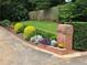 Beautiful landscaping with a brick mailbox planter with well-maintained shrubbery for added curb appeal at 4094 Carlisle Pl, Stone Mountain, GA 30083