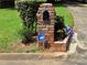 Brick mailbox next to vibrant flowers and lush green foliage enhances curb appeal at 4094 Carlisle Pl, Stone Mountain, GA 30083