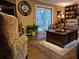 Comfortable living room with hardwood floors, a decorative clock, and sliding glass doors to outdoor patio at 4094 Carlisle Pl, Stone Mountain, GA 30083