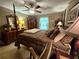 Comfortable bedroom features a canopy bed, ceiling fan, and wooden furniture at 4094 Carlisle Pl, Stone Mountain, GA 30083