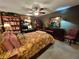 Comfortable bedroom features a bed, ceiling fan, bookcase, and wooden furniture at 4094 Carlisle Pl, Stone Mountain, GA 30083