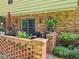 Charming brick patio with outdoor seating, a large umbrella, and lush greenery surrounding the space at 4094 Carlisle Pl, Stone Mountain, GA 30083