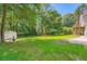 Well-maintained backyard with lush lawn, mature trees, and shed for ample outdoor enjoyment at 113 Hitchcock Dr, Villa Rica, GA 30180