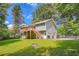 Charming home with a spacious backyard, wooden deck, and plenty of greenery at 113 Hitchcock Dr, Villa Rica, GA 30180