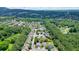 An aerial view of a neighborhood and a home surrounded by lush trees and greenery at 4003 Coachman Ct, Cumming, GA 30040