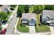 Aerial shot of a two-story home with a manicured lawn, landscaping, and a white picket fence at 4003 Coachman Ct, Cumming, GA 30040