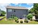 Backyard view of the home featuring a patio, grill, and manicured landscaping at 4003 Coachman Ct, Cumming, GA 30040