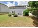 Spacious, grassy backyard of a two-story home features lush landscaping, a patio, and a fire pit at 4003 Coachman Ct, Cumming, GA 30040