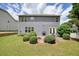 Large backyard with patio, fire pit, grill and well maintained shrubs on a two-story home at 4003 Coachman Ct, Cumming, GA 30040