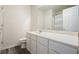 Clean, bright bathroom with a long white vanity, simple fixtures, and dark wood-look floors at 4003 Coachman Ct, Cumming, GA 30040
