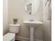 Powder room with a pedestal sink and neutral walls at 4003 Coachman Ct, Cumming, GA 30040
