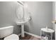 Cozy bathroom with white toilet, sink, and table with dark-wood laminate flooring at 4003 Coachman Ct, Cumming, GA 30040