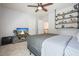 Serene bedroom featuring a gray color palette, simple furnishings, and a functional shelving unit at 4003 Coachman Ct, Cumming, GA 30040