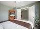 Bright bedroom with a built-in bookshelf and TV, next to open doors leading to a carpeted area at 4003 Coachman Ct, Cumming, GA 30040